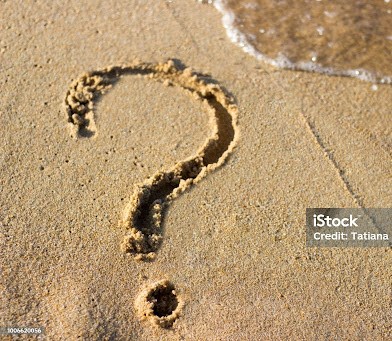 question mark sign in sand beach